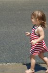 Young Girl in Red Dress Walking